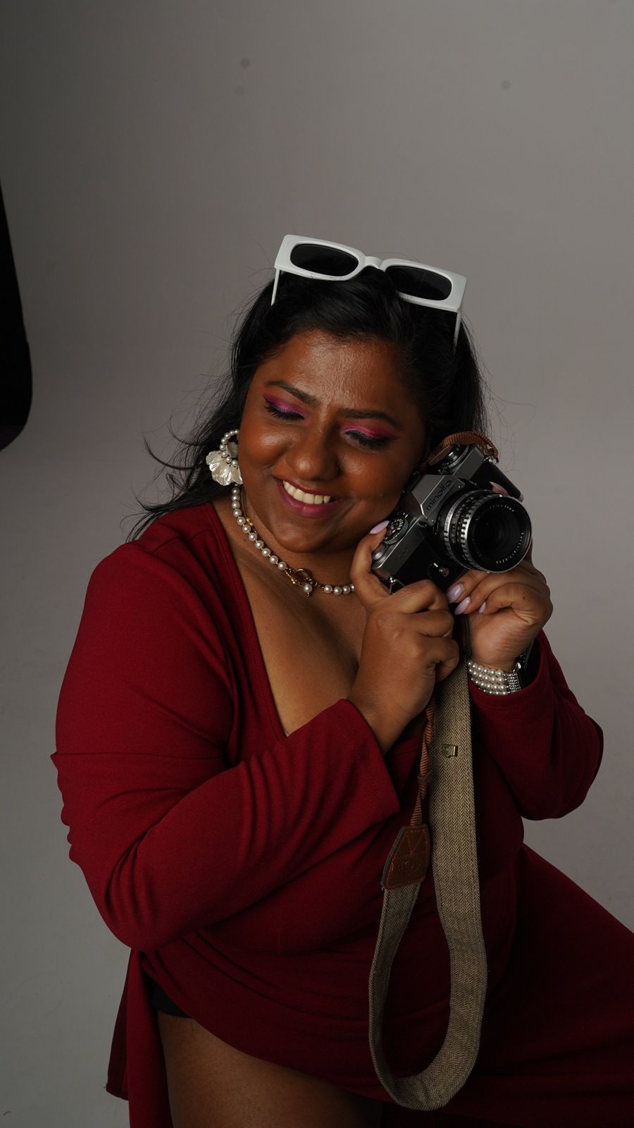 Lakshmi smiling with her camera