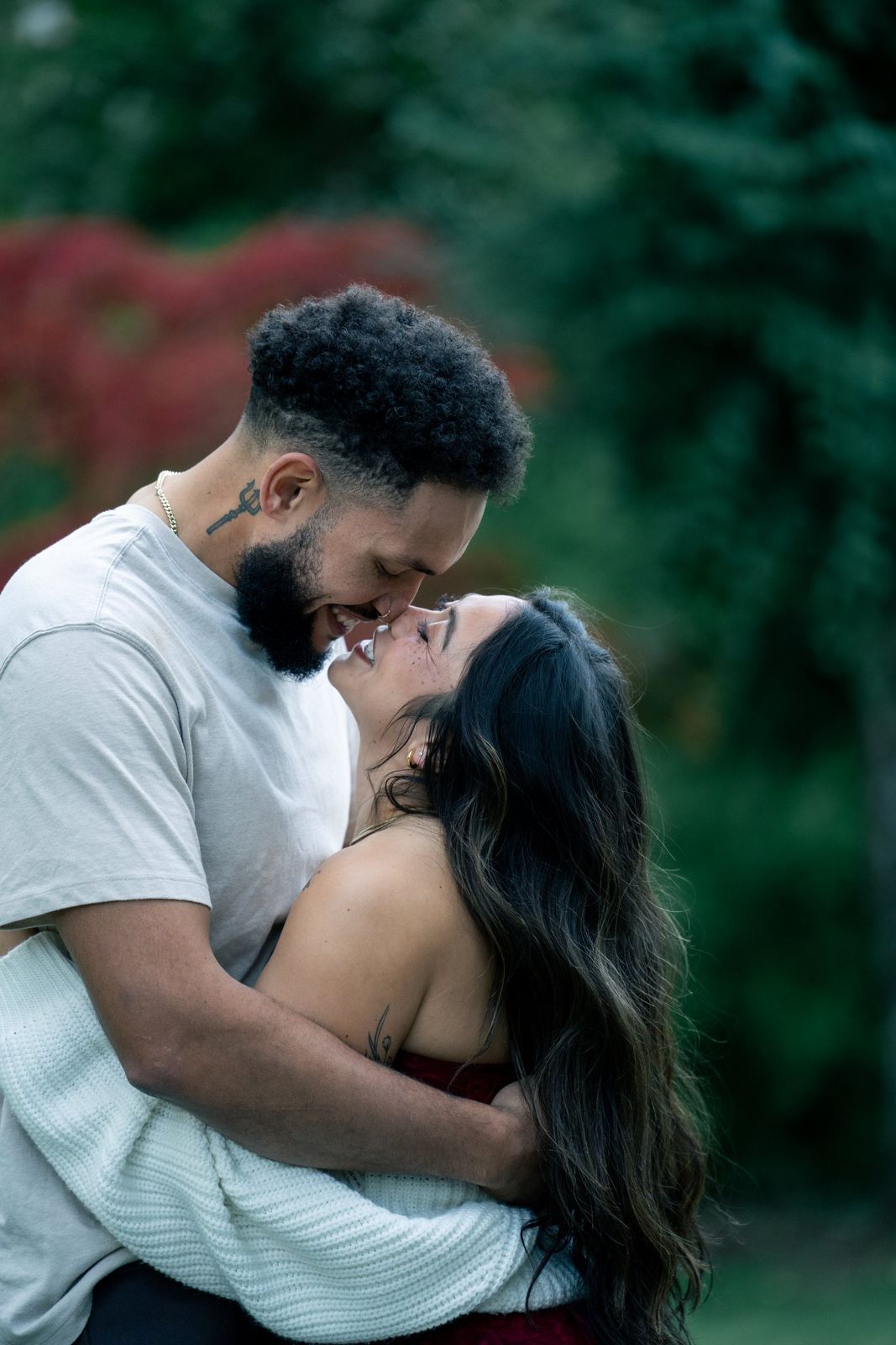 Couple embracing among autumn leaves